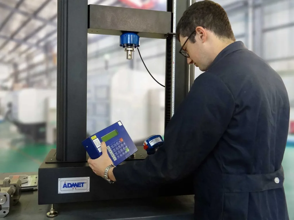A worker performs a calibration on a testing machine