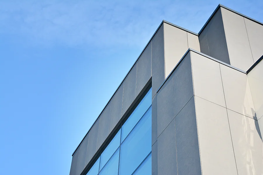 Glass and concrete building against blue sky