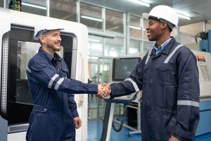 Image of two men shaking hands in a production environment