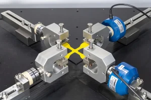 Close up image of planar biaxial cruciform sample on eXpert 6000 testing machine
