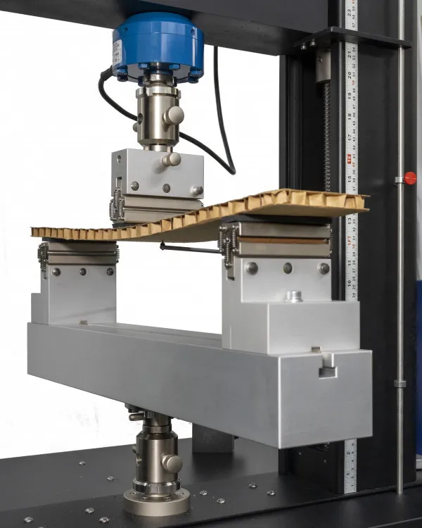 Image of eXpert 2600 with mounted bend fixture performing a test on a sandwich construction composite