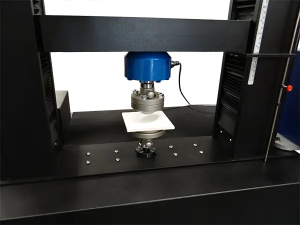Image of ASTM C1499 bend fixture on eXpert 2600 testing machine