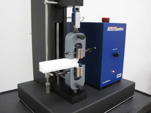 Image of foam tear sample in vise grips mounted on an eXpert 7600