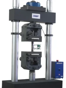 Image of wedge grips, test sample, and attached extensometer for ASTM E8 testing