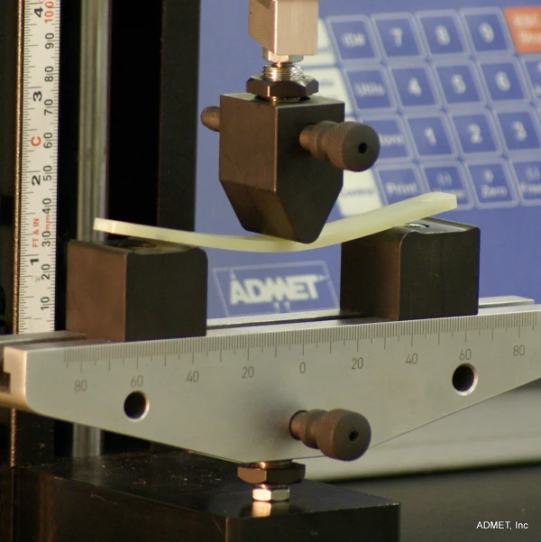 Bend fixture and sample mounted to testing machine for ASTM D790 testing