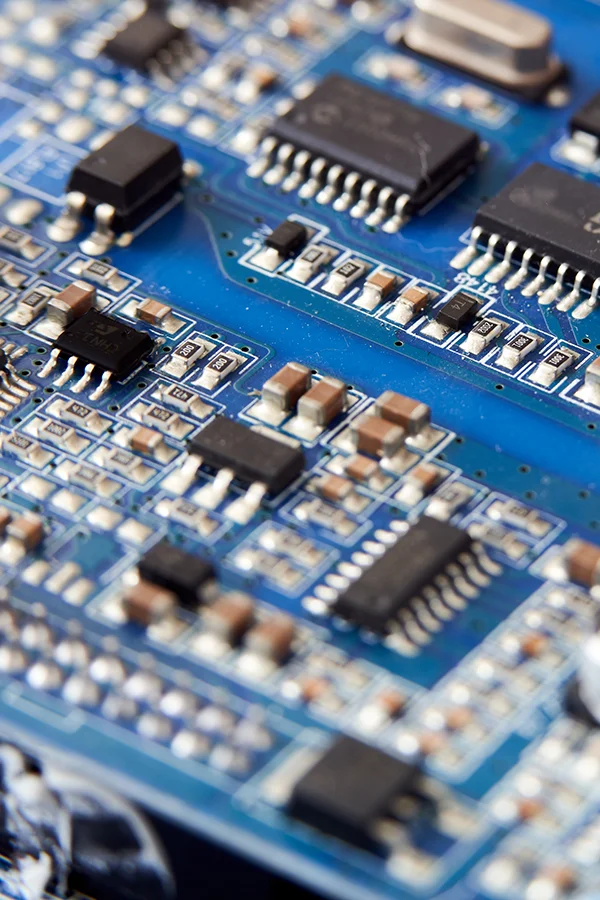 Blue circuit board with electronic components.
